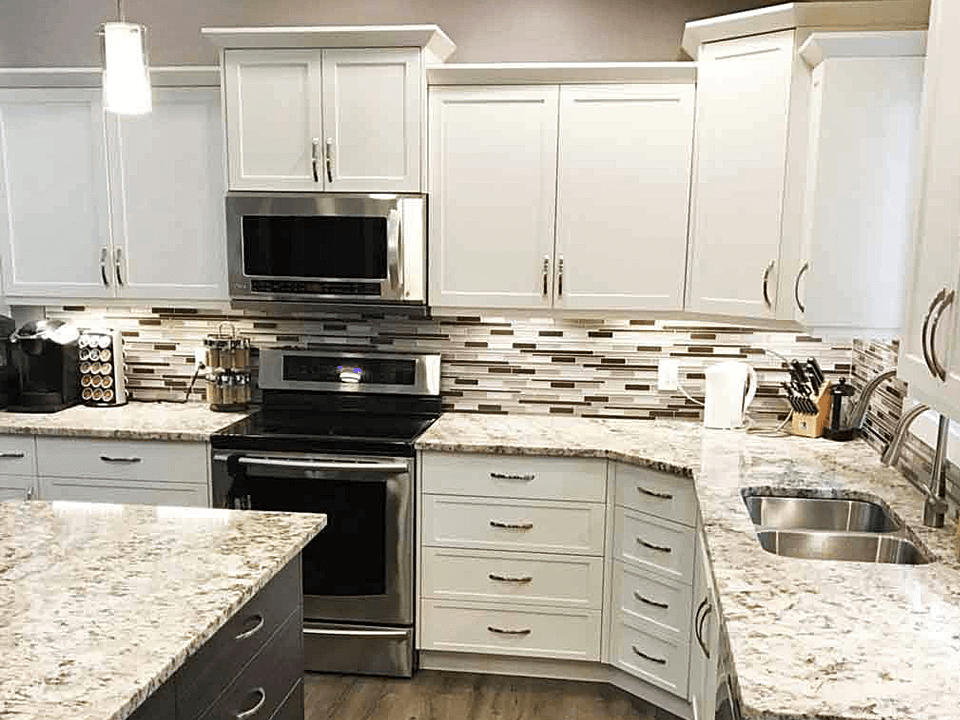 A Kitchen with White Cabinets and Stone Countertop