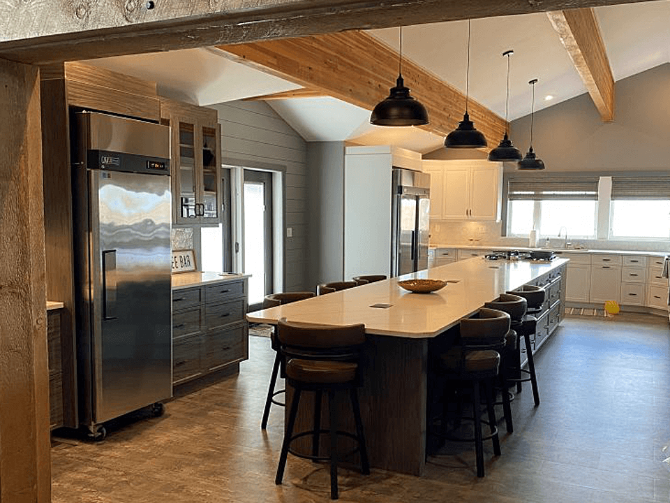 A Large Kitchen with Beautiful Cabinets and Large Island with Granite Countertop