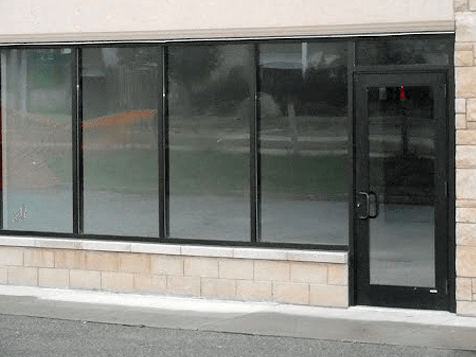 Picture of a Commercial Retail Building Exterior with Windows and Door.